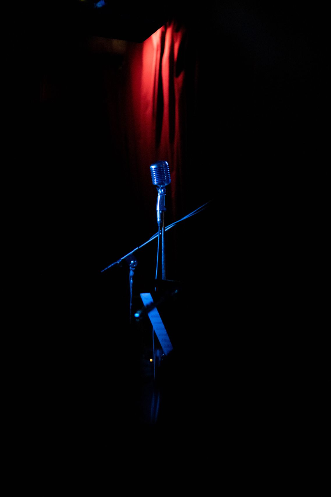 Microphone on a stand with a lightbox sign reading YOUR VOICE MATTERS